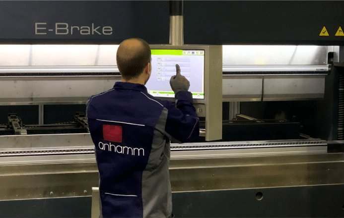 Worker operating industrial machinery control panelt in Anhamm factory for fire protection solutions for businesses