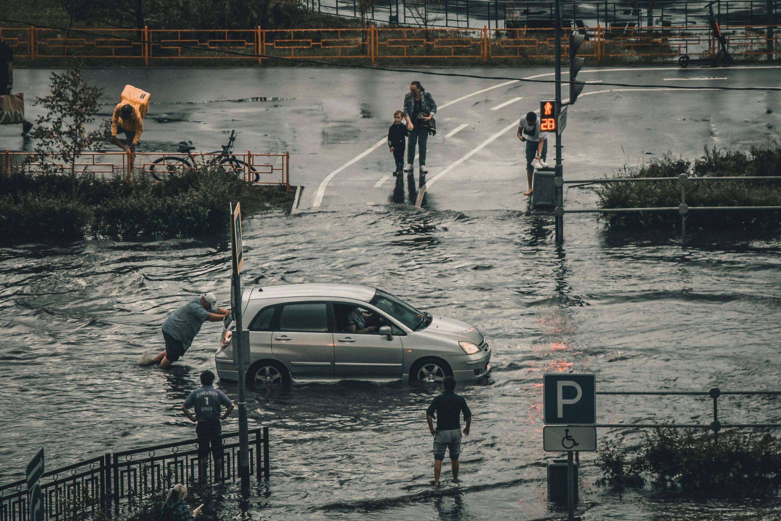 climate change flooding with submerged cars demonstrating the need for effective flood barriers and spill protection systems